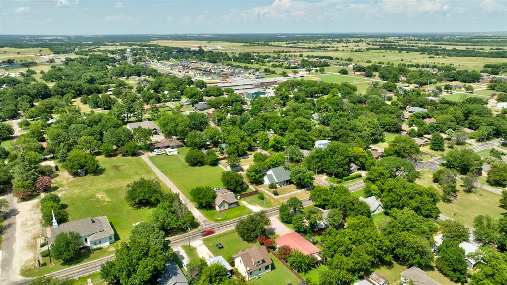 503 Sherman Street Tioga, TX 76271 - Photo 12 of 13 Aerial perspective showcasing a residential area with extensive tree coverage and open green spaces
