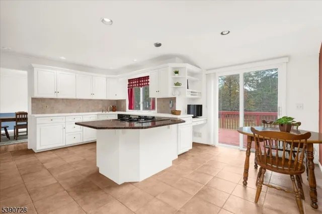 a kitchen with a sink and chairs