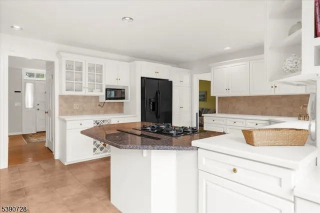 a kitchen with stainless steel appliances granite countertop a sink and a stove