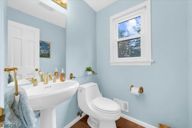 a bathroom with a sink mirror and toilet