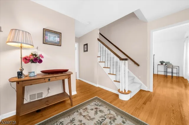 a view of entryway livingroom and hall with wooden floor