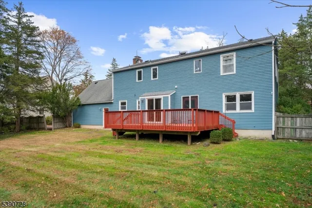 a view of a house with a yard and deck