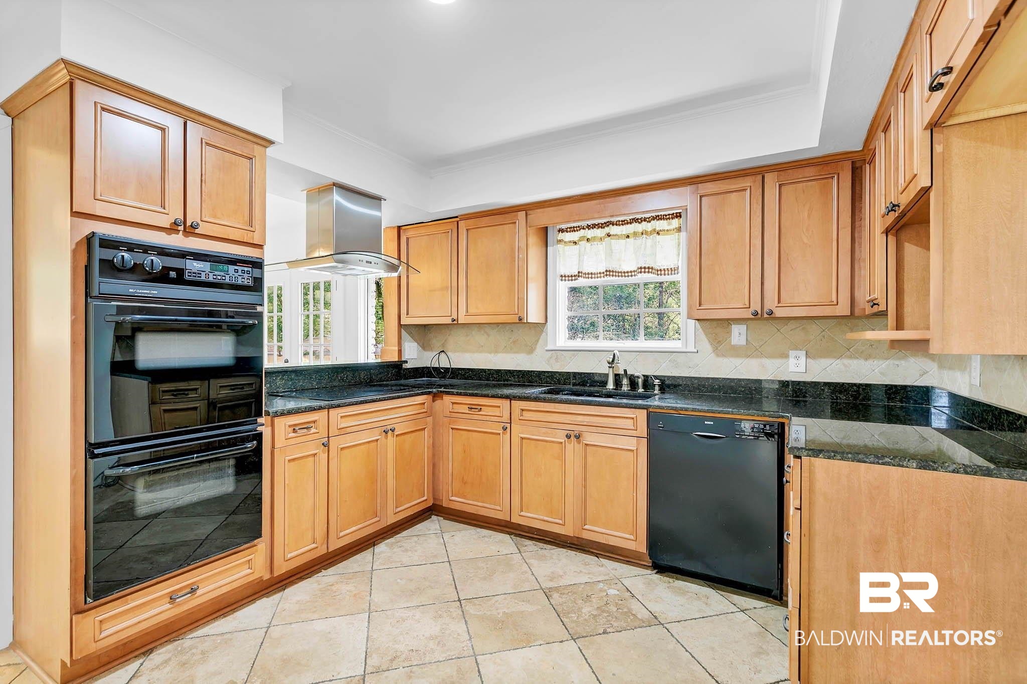 4705 Sherry Court Mobile, AL 36693 - Photo 18 of 100 Kitchen with black appliances, island range hood, decorative backsplash, and light tile patterned floors