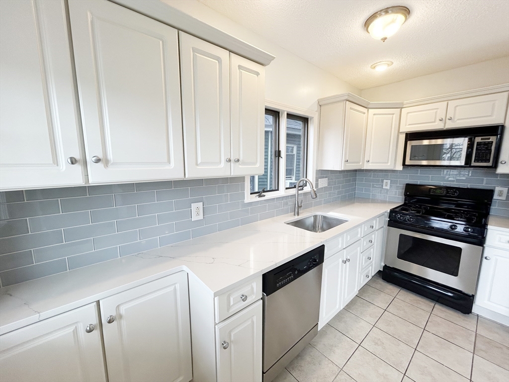 80 Linden Street, Unit 80 Salem, MA 01970 - Photo 13 of 35 a kitchen with stainless steel appliances granite countertop a sink and a stove
