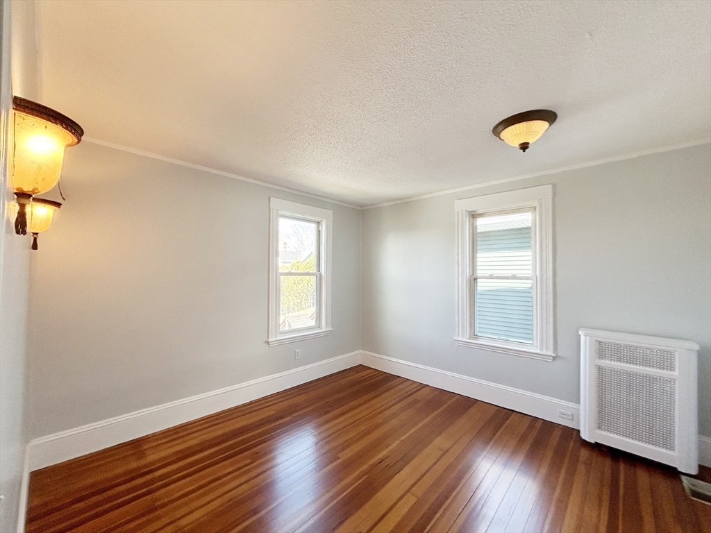 80 Linden Street, Unit 80 Salem, MA 01970 - Photo 17 of 35 wooden floor in an empty room with a window and wooden floor