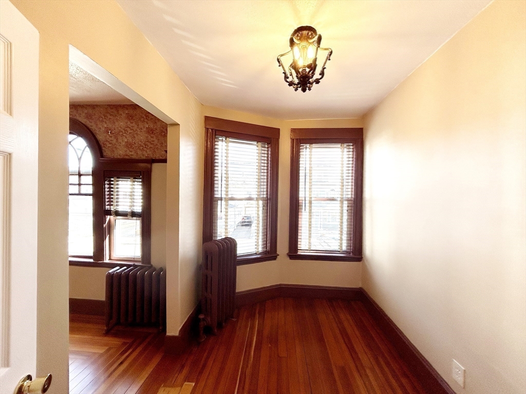 80 Linden Street, Unit 80 Salem, MA 01970 - Photo 23 of 35 a view of empty room with a window and wooden floor
