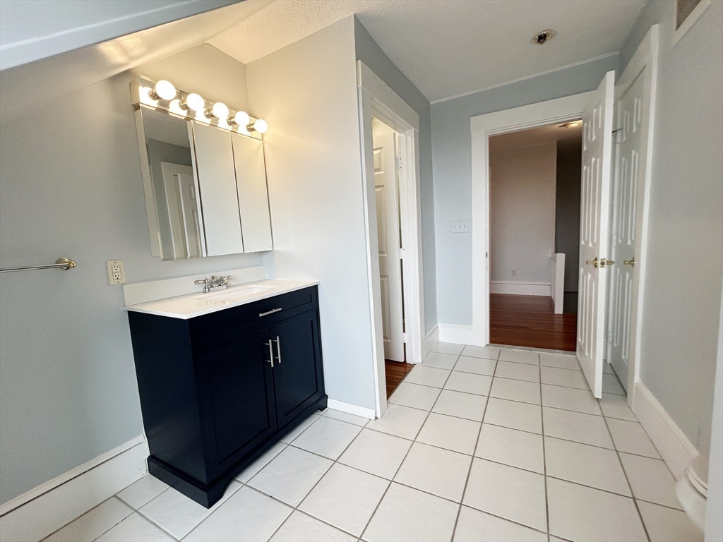 80 Linden Street, Unit 80 Salem, MA 01970 - Photo 32 of 35 a bathroom with a sink vanity and a mirror