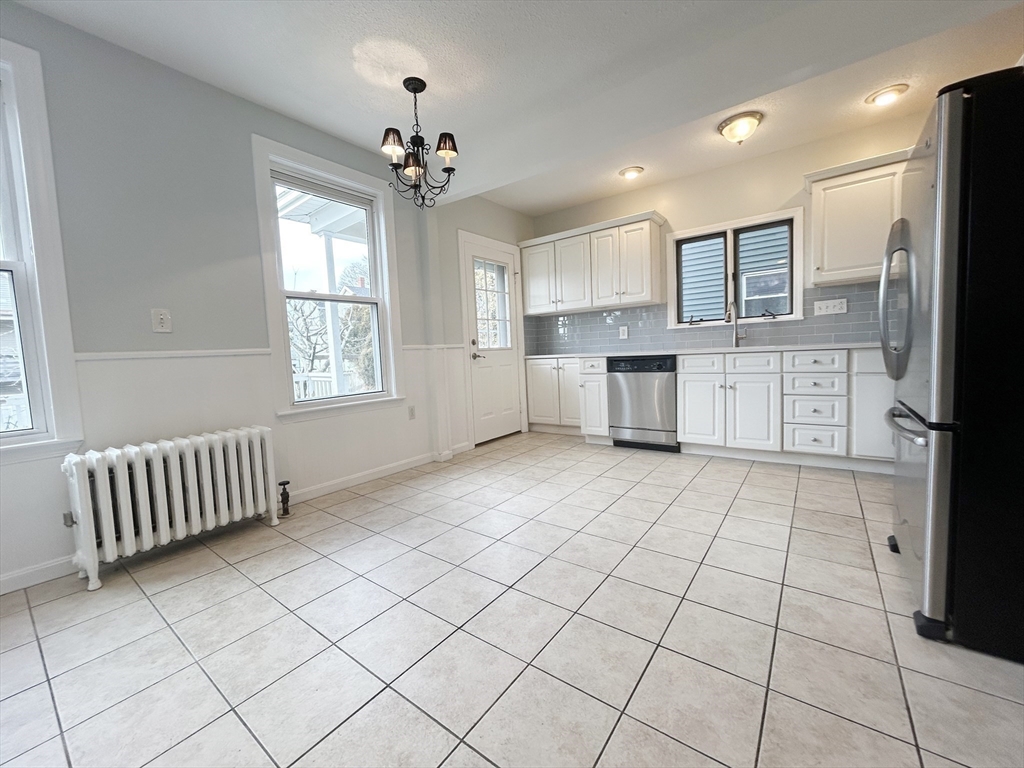 80 Linden Street, Unit 80 Salem, MA 01970 - Photo 8 of 35 a large white kitchen with cabinets