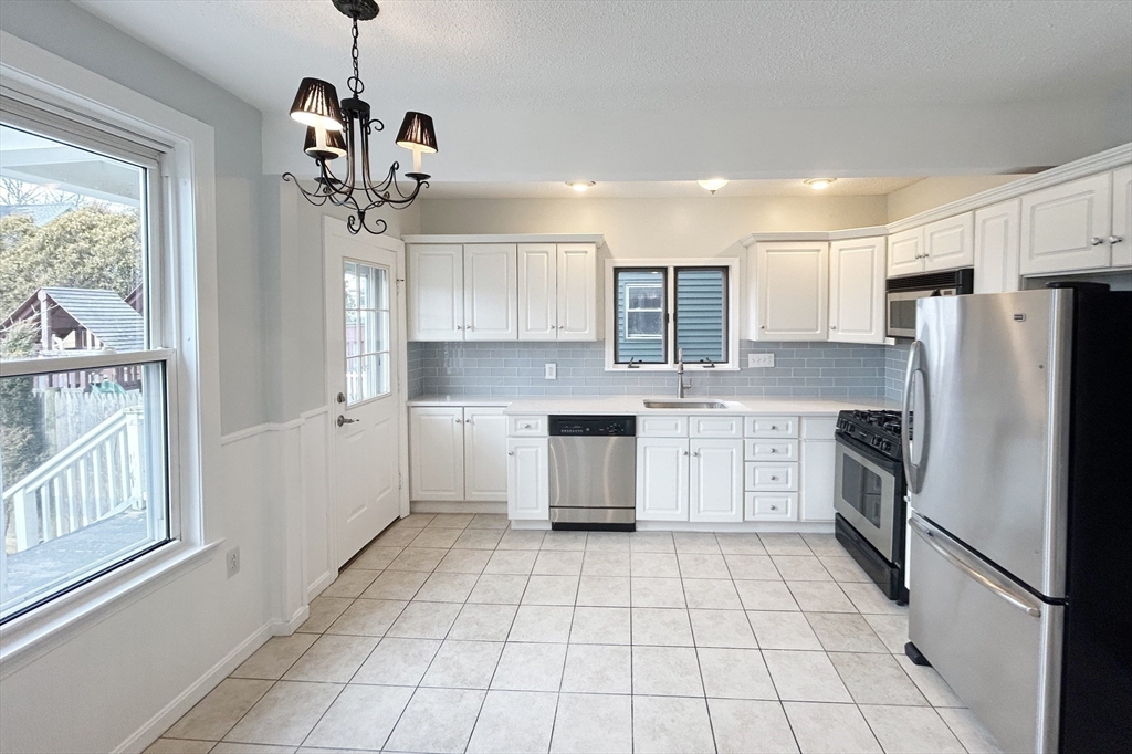 80 Linden Street, Unit 80 Salem, MA 01970 - Photo 9 of 35 a kitchen with stainless steel appliances granite countertop a refrigerator and a sink