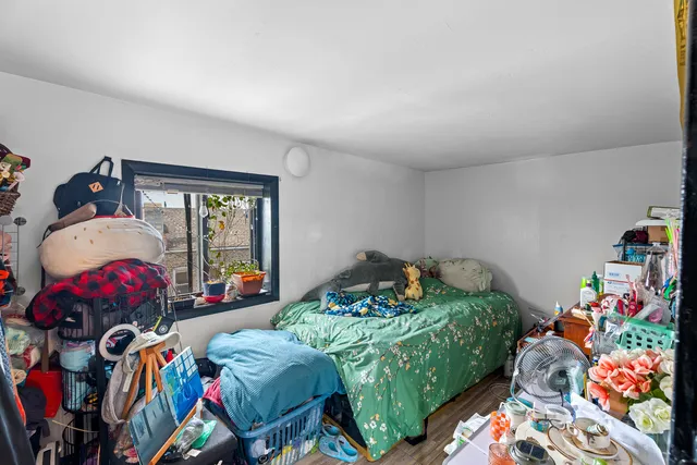 a living room with furniture a flat screen tv and a floor to ceiling window