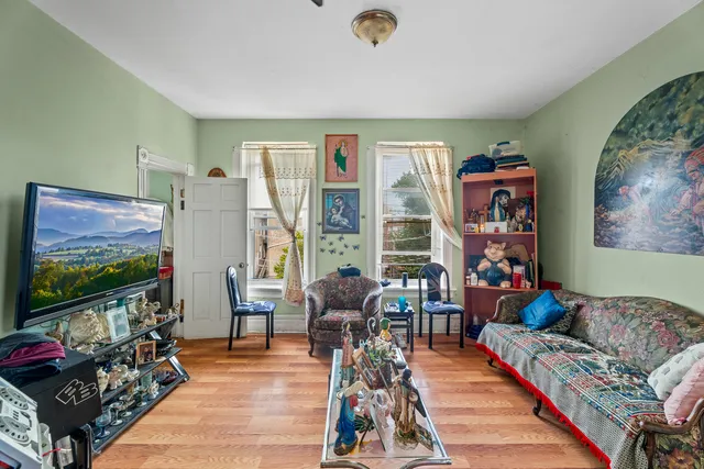 a room with furniture a rug toys and a window