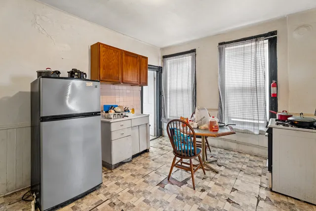 a bedroom with a bed and a computer on the desk