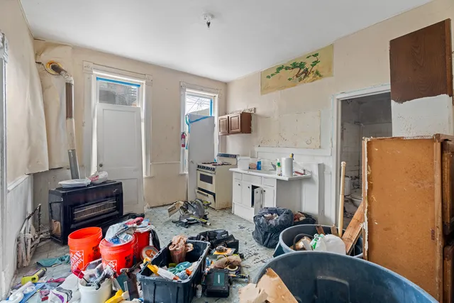 a kitchen with stainless steel appliances kitchen island granite countertop a stove refrigerator and sink