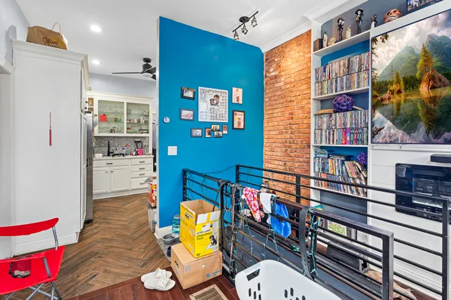 a living room with fireplace furniture and a book shelf