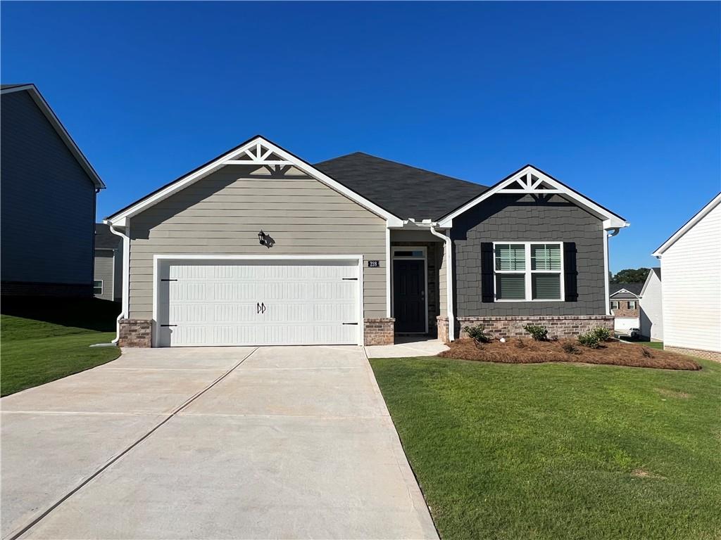 260 Canberra Way Locust Grove, GA 30248 - Photo 1 of 1 a front view of a house with a yard