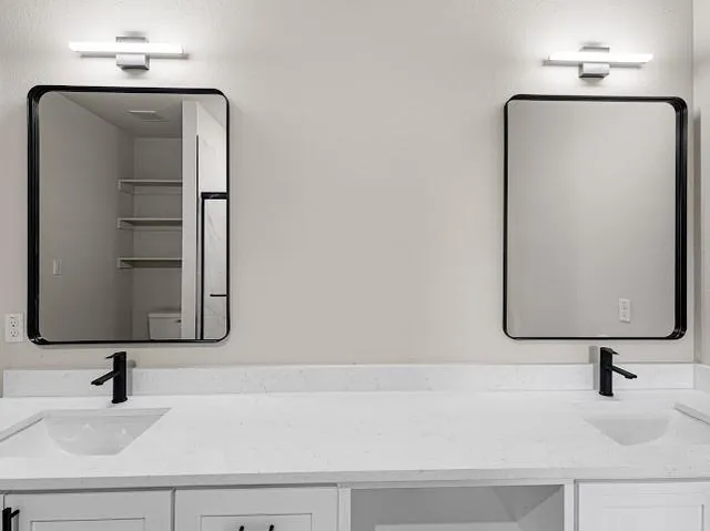 an empty room with a ceiling fan and carpet