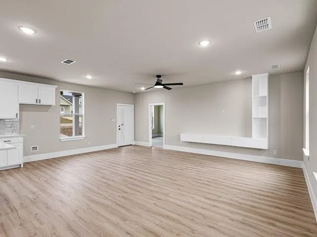 a view of kitchen with cabinets stainless steel appliances with wooden floor