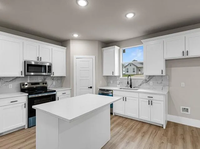 a view of kitchen with wooden floor and window