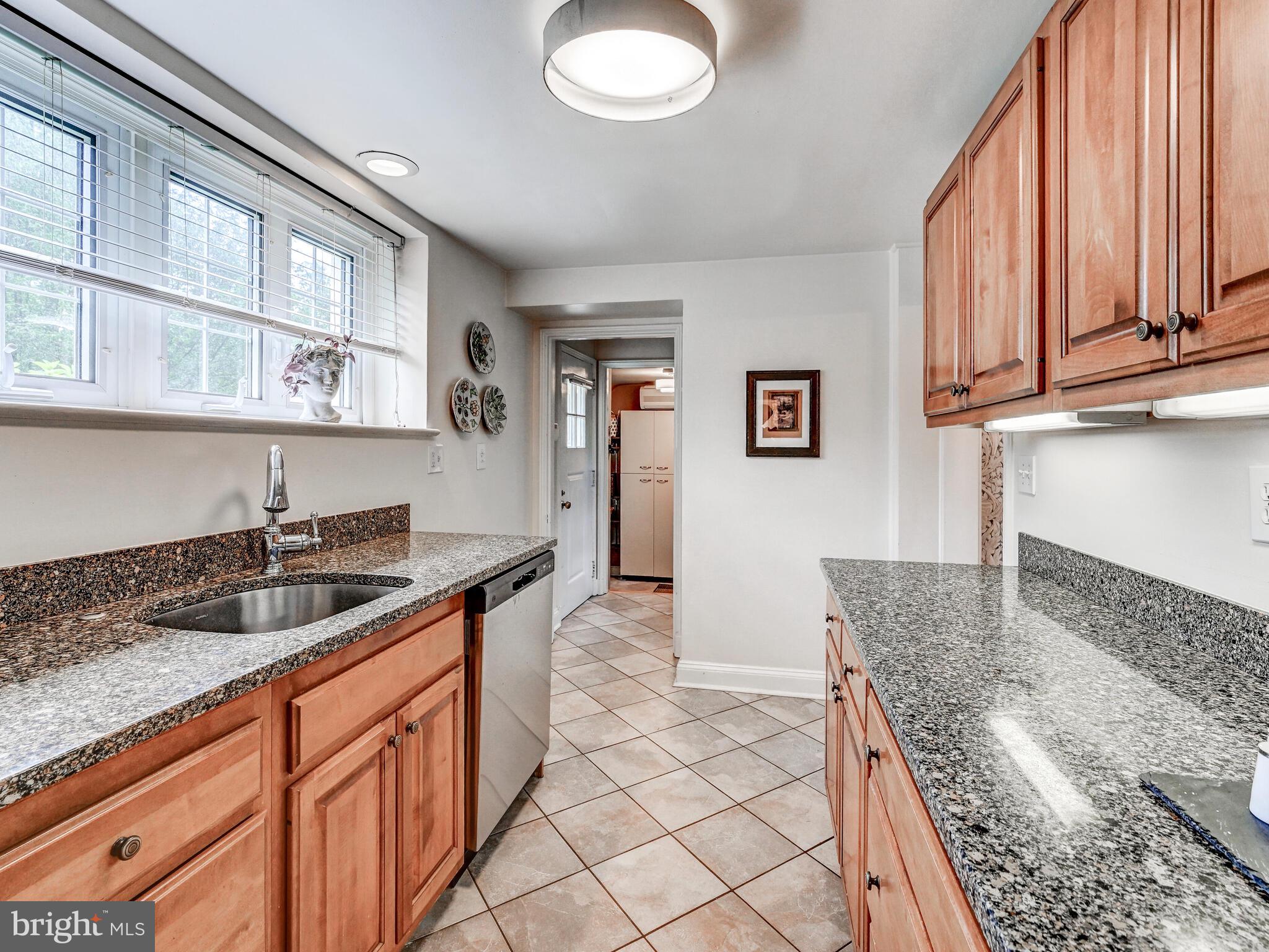 209 Paddington Road Baltimore, MD 21212 - Photo 18 of 36 a kitchen with granite countertop a sink and a stove