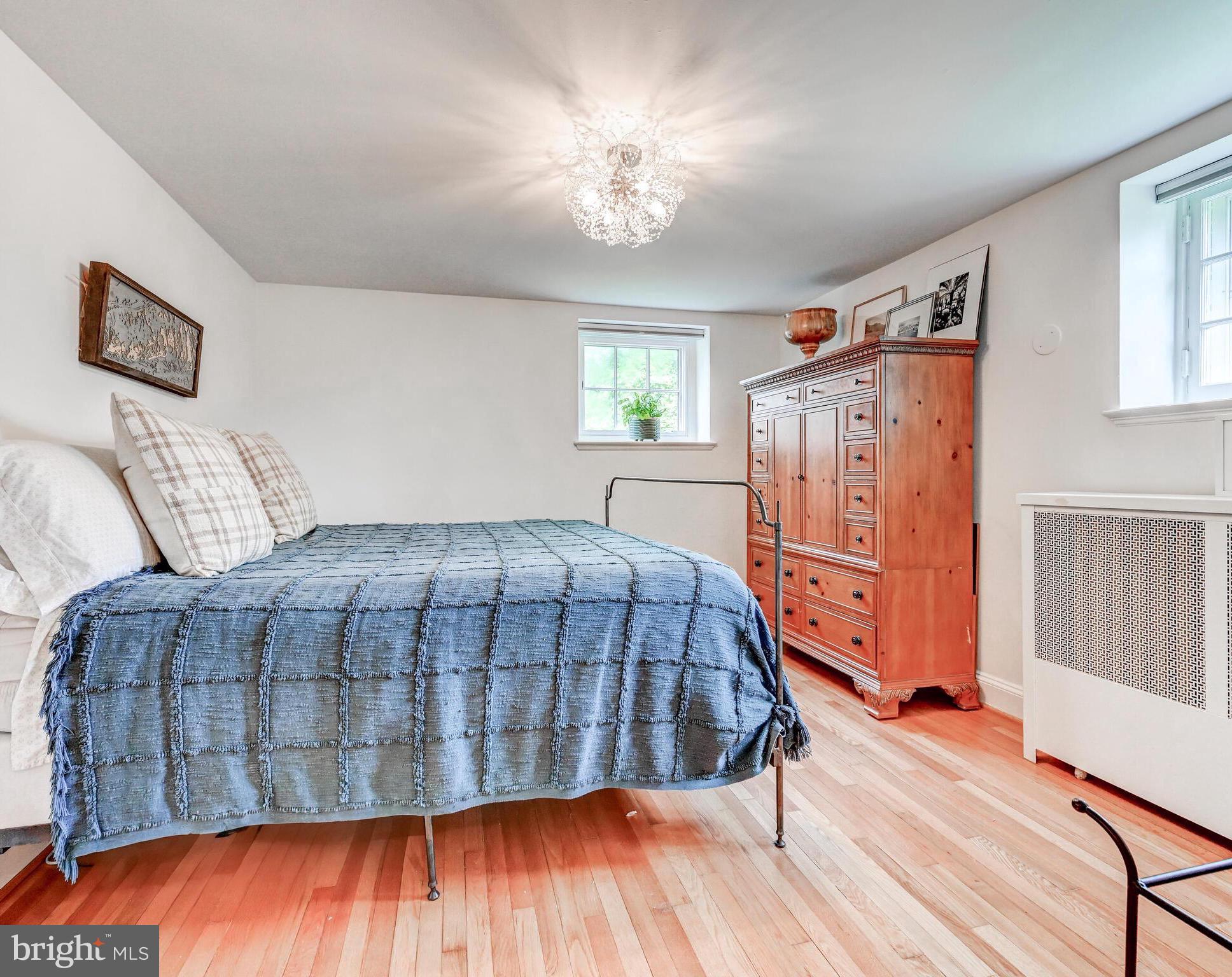 209 Paddington Road Baltimore, MD 21212 - Photo 20 of 36 a bedroom with a bed and wooden floor