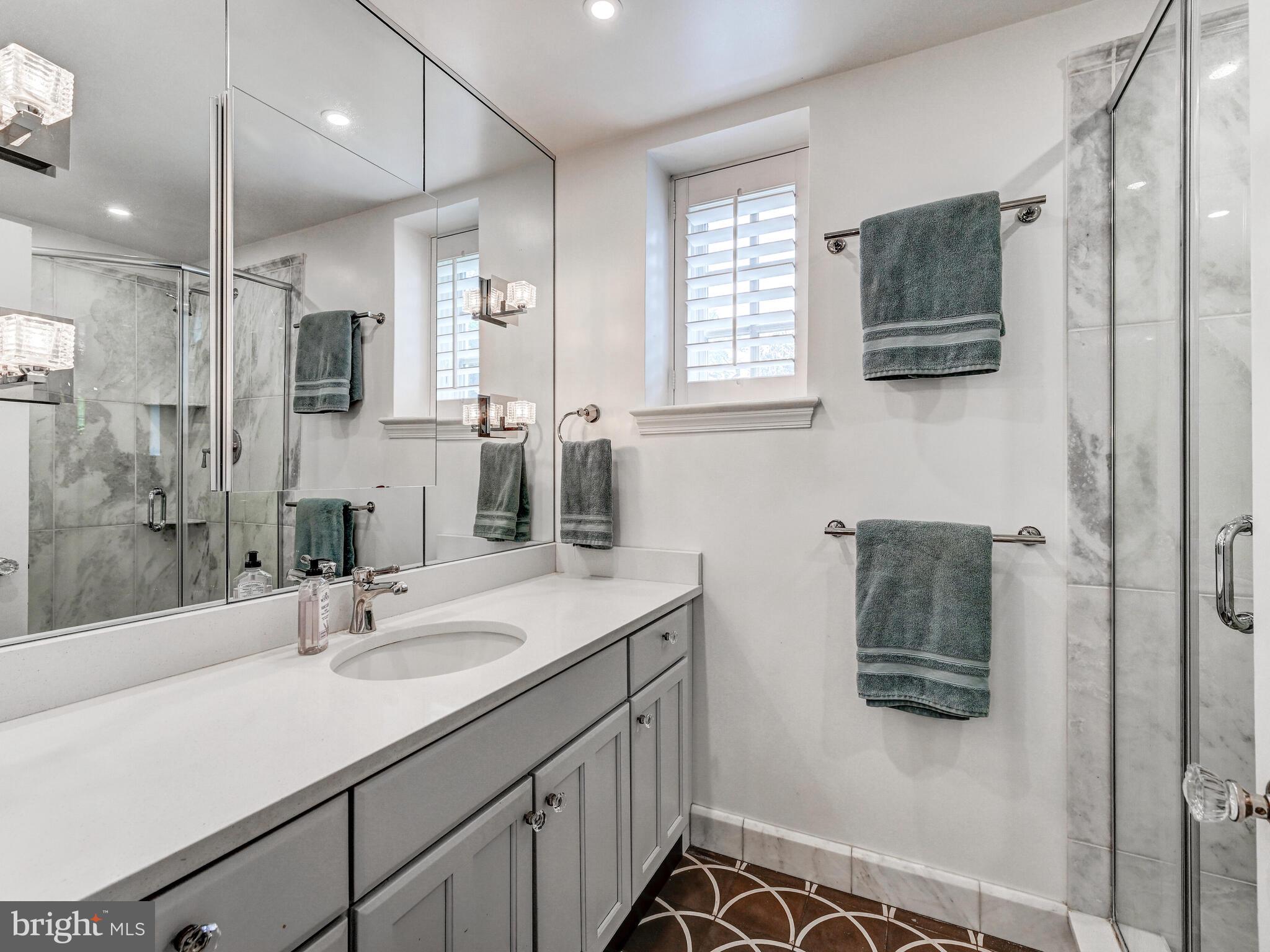 209 Paddington Road Baltimore, MD 21212 - Photo 21 of 36 a bathroom with a double vanity sink a mirror and shower