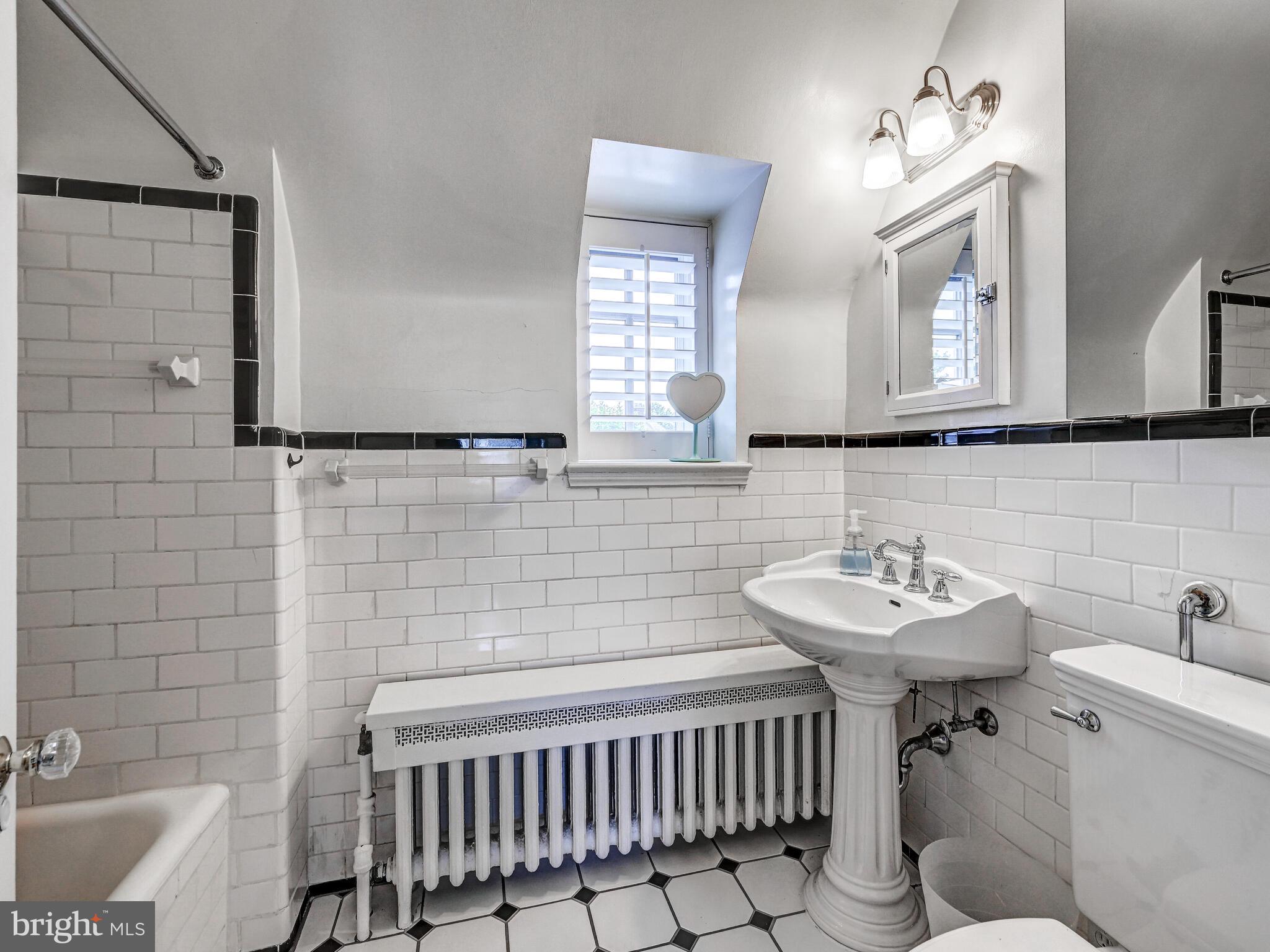 209 Paddington Road Baltimore, MD 21212 - Photo 24 of 36 a bathroom with a sink toilet and a mirror