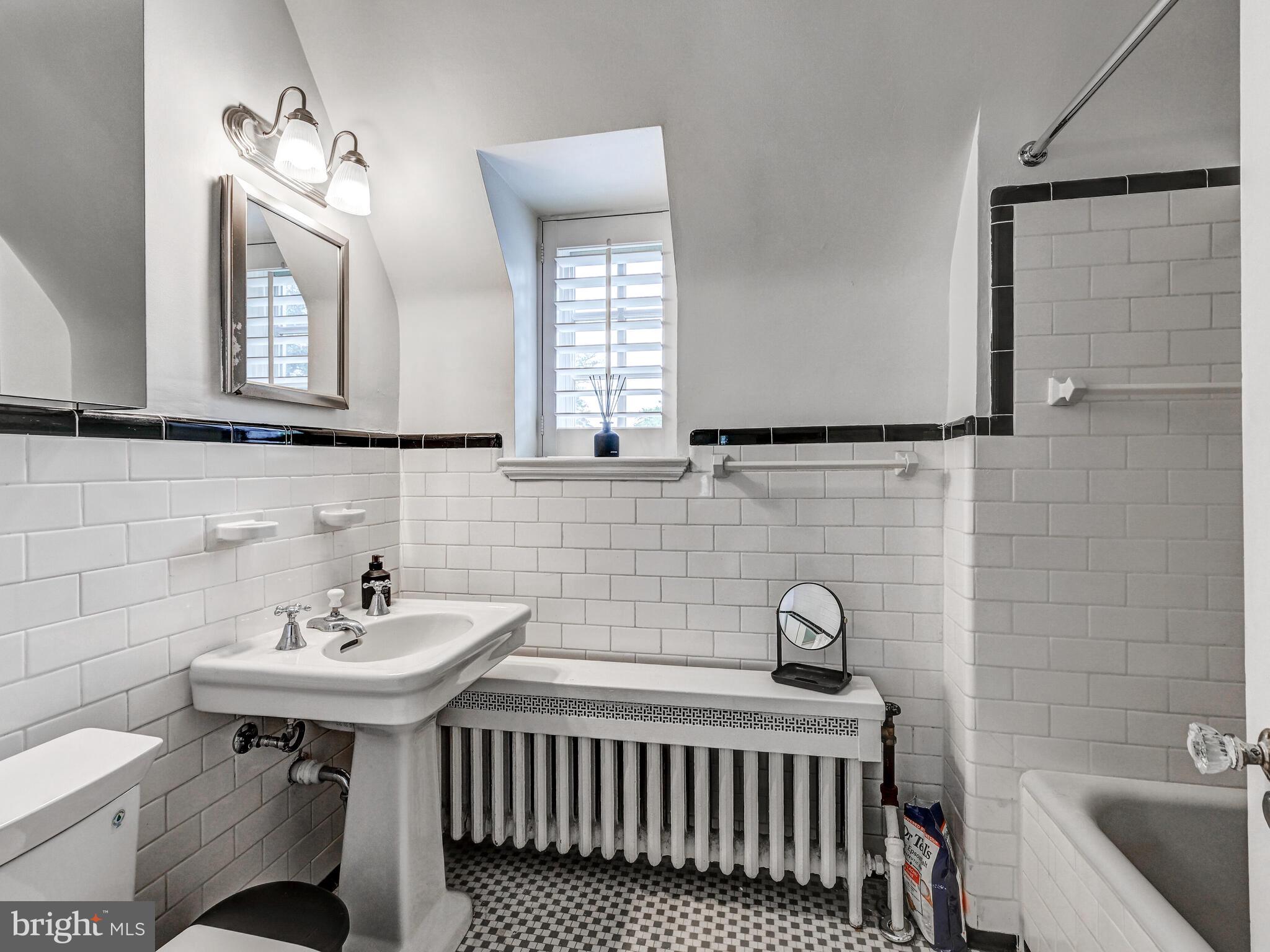 209 Paddington Road Baltimore, MD 21212 - Photo 26 of 36 a bathroom with a sink and a mirror