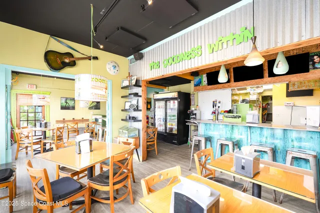 a dining area with glass top table and chairs