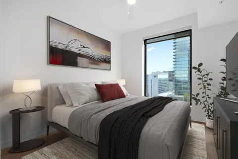 a bedroom with bed and a window