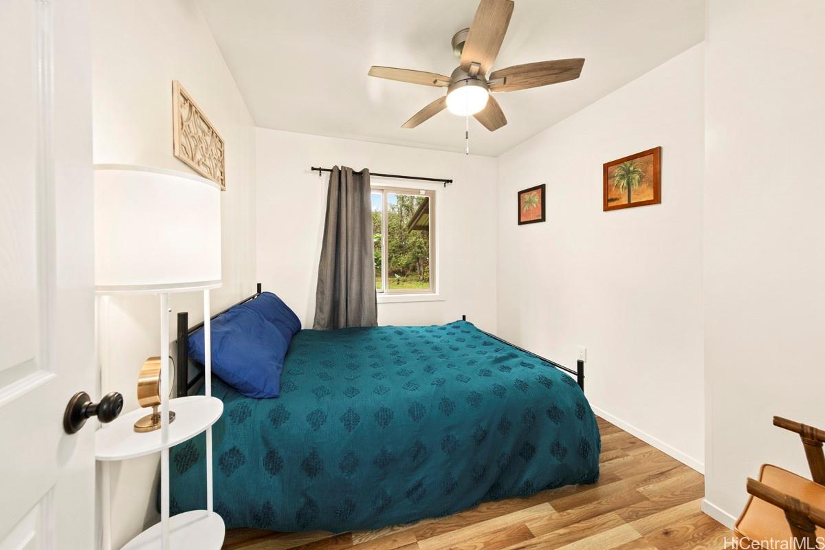 18-2274 Laulea Road Volcano, HI 96785 - Photo 11 of 15 Bedroom with ceiling fan and natural light, positioned for comfort within this Volcano area home