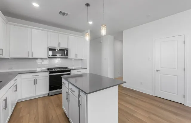 a view of a hallway with a wooden floor