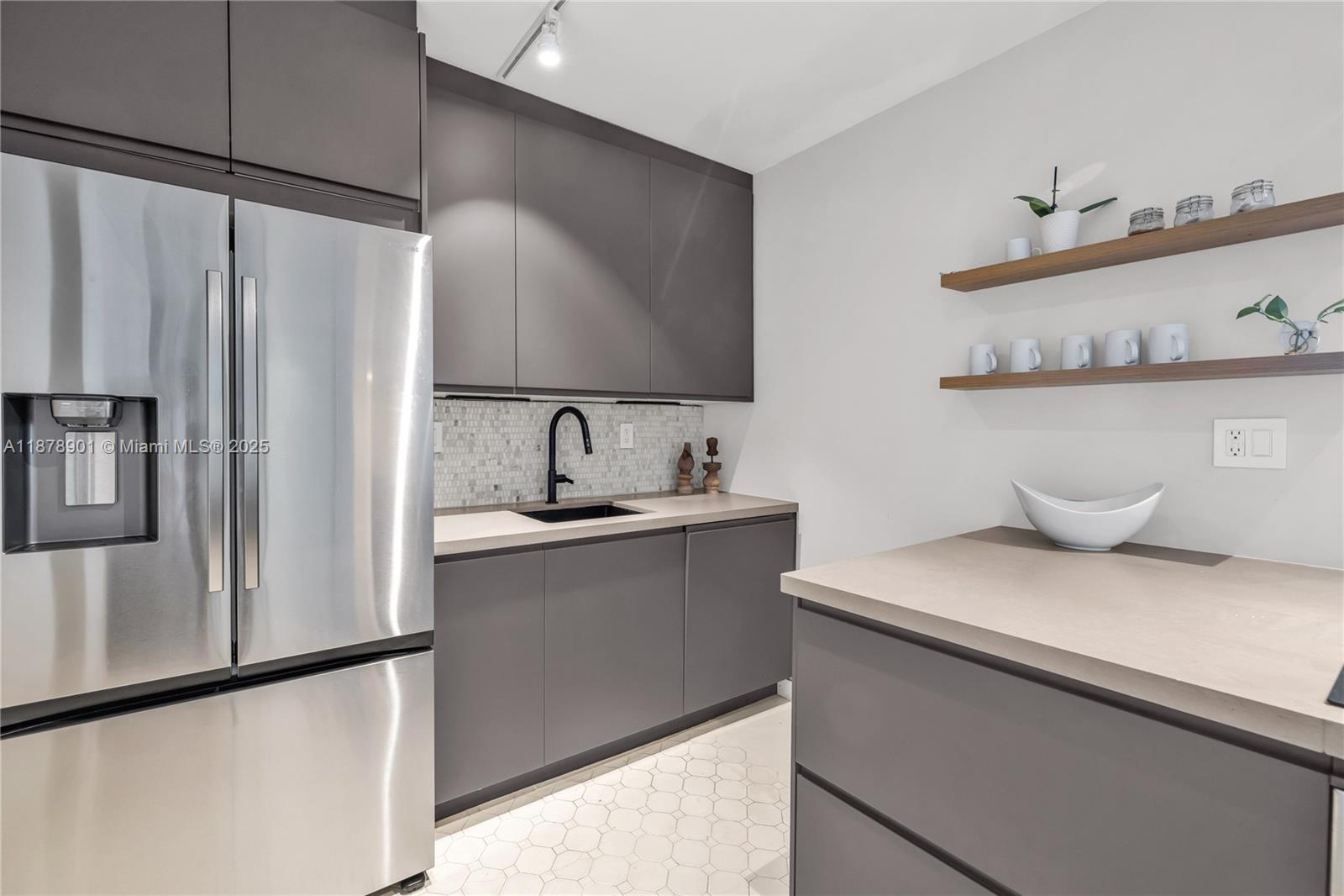 770 Northeast 69th Street, Unit 6H Miami, FL 33138 - Photo 11 of 71 a kitchen with stainless steel appliances a sink and a refrigerator