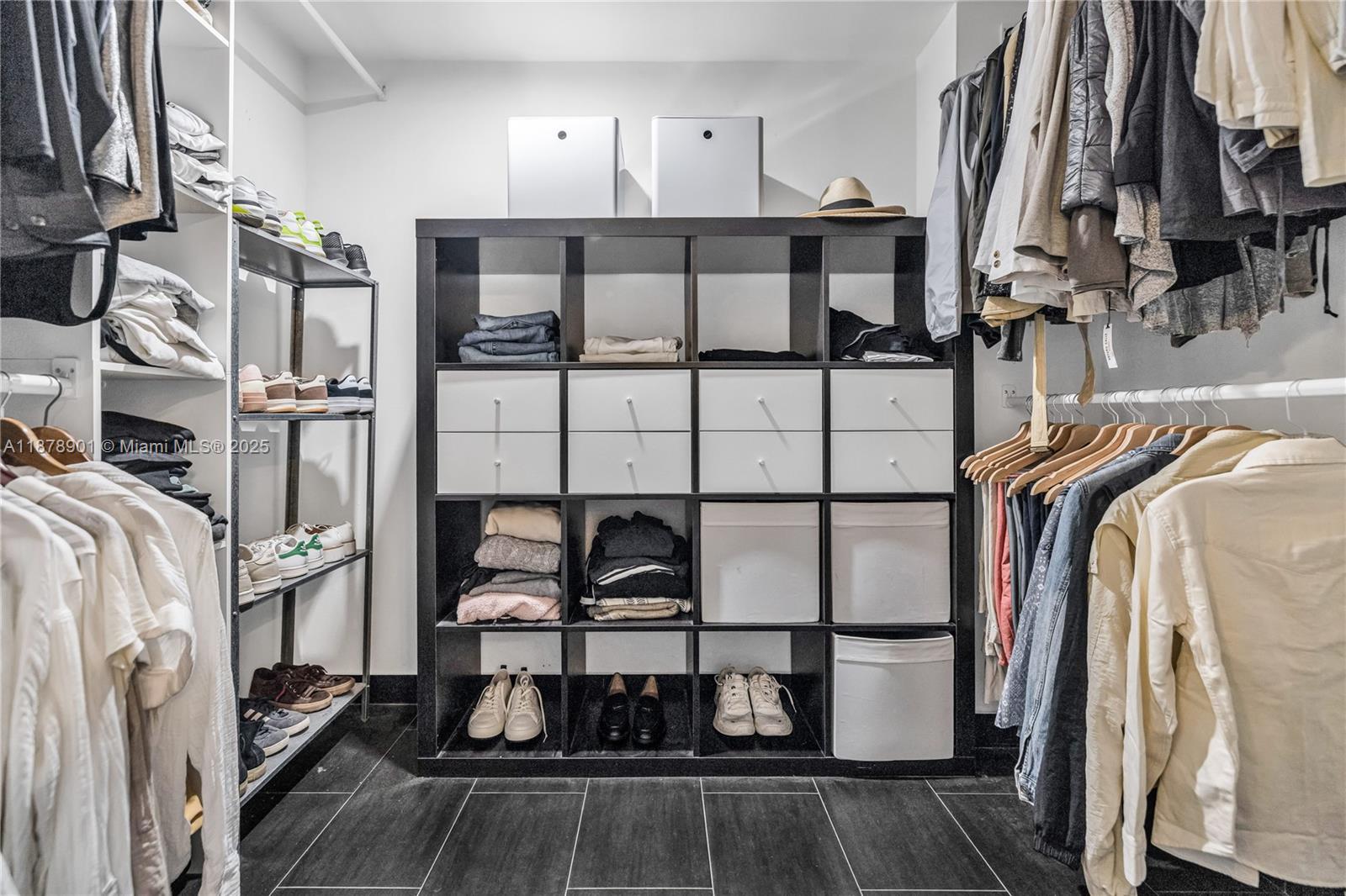 770 Northeast 69th Street, Unit 6H Miami, FL 33138 - Photo 30 of 71 a view of walk in closet with clothes and shoes