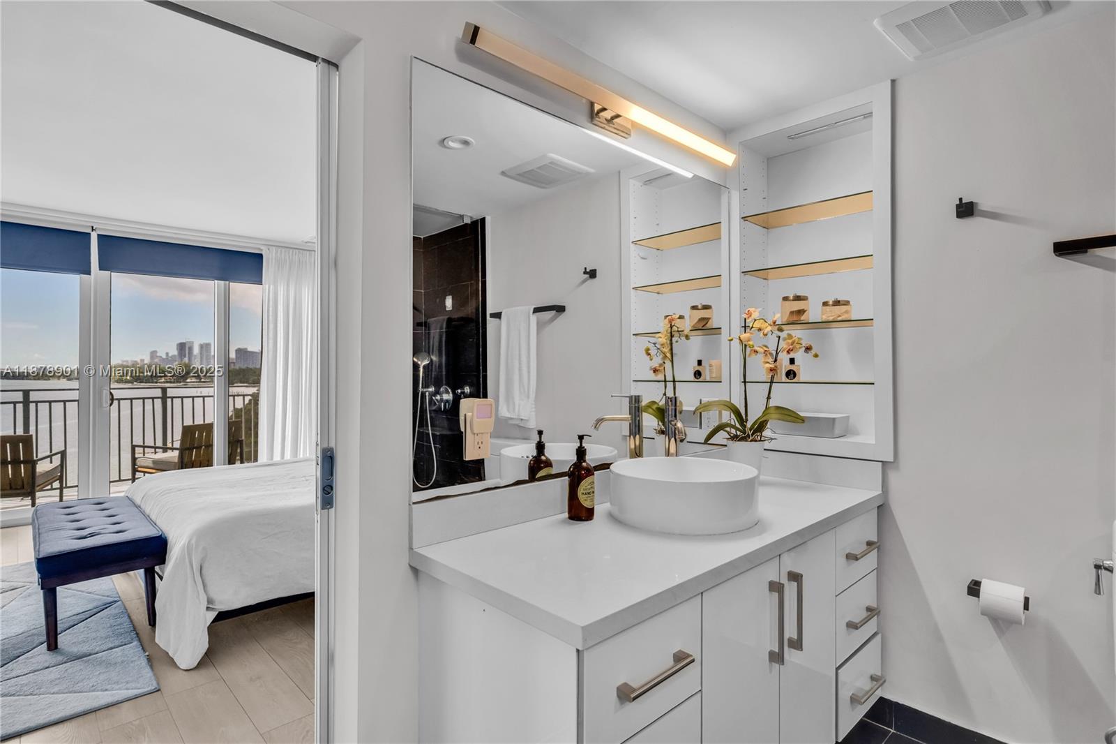770 Northeast 69th Street, Unit 6H Miami, FL 33138 - Photo 31 of 71 a en suite bathroom with a sink double vanity and a mirror