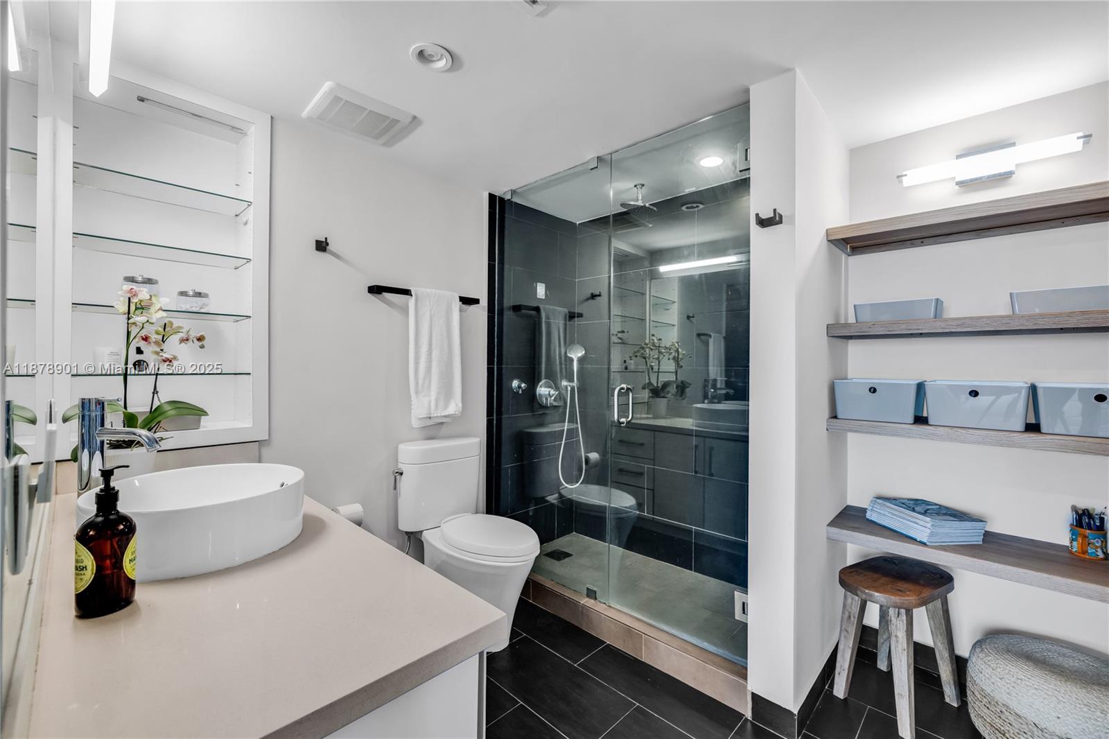 770 Northeast 69th Street, Unit 6H Miami, FL 33138 - Photo 32 of 71 a bathroom with a tub a sink and a mirror