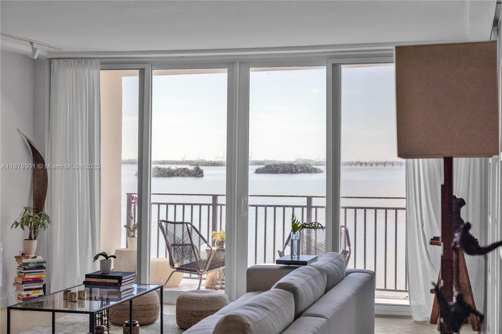 770 Northeast 69th Street, Unit 6H Miami, FL 33138 - Photo 55 of 71 a living room with furniture and a floor to ceiling window