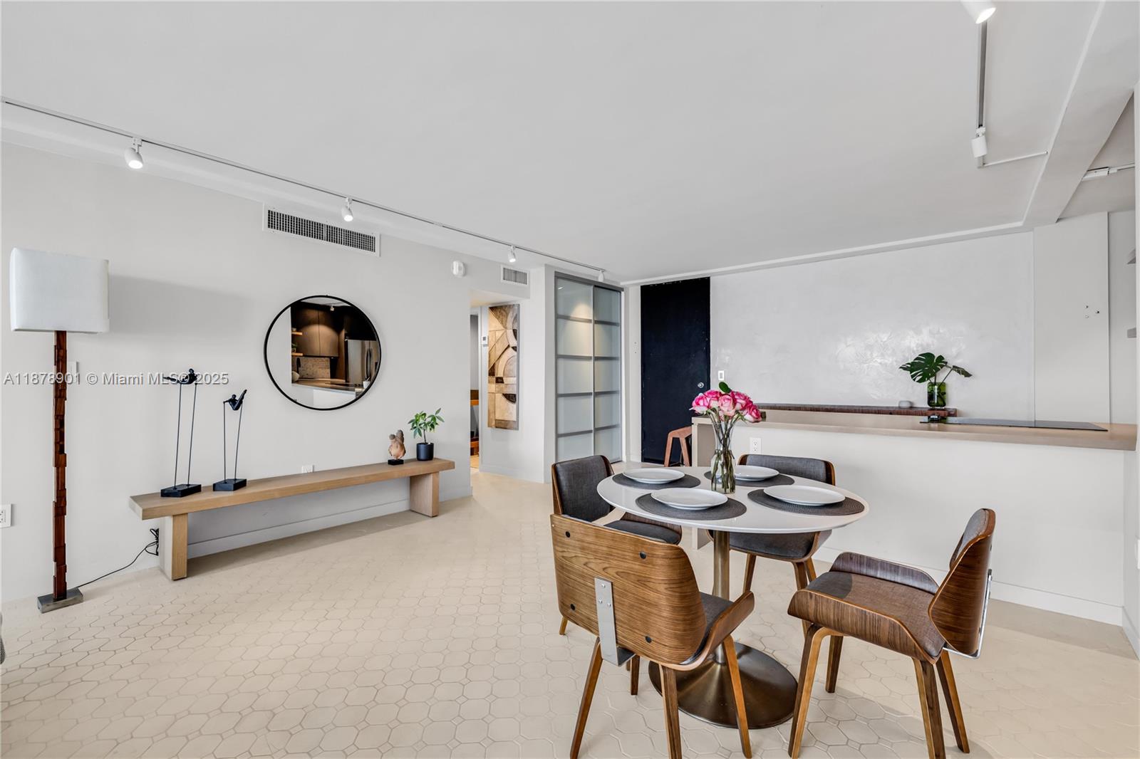 770 Northeast 69th Street, Unit 6H Miami, FL 33138 - Photo 60 of 71 a dining room with furniture and a mirror