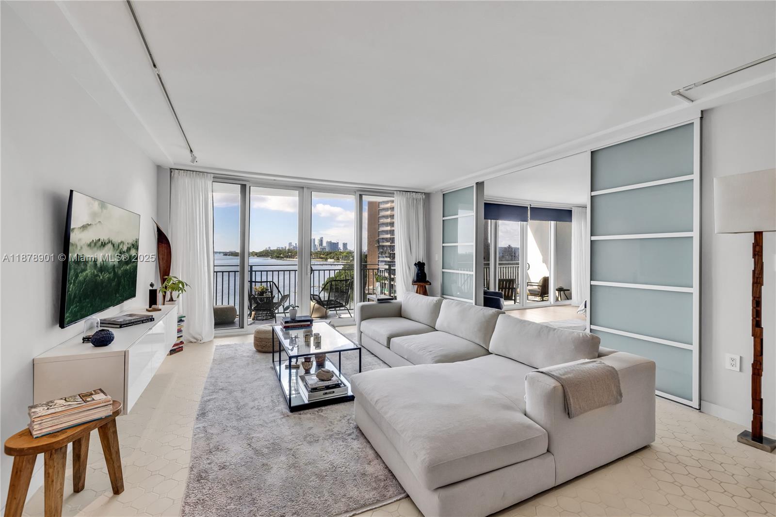 770 Northeast 69th Street, Unit 6H Miami, FL 33138 - Photo 66 of 71 a living room with furniture large window and a flat screen tv