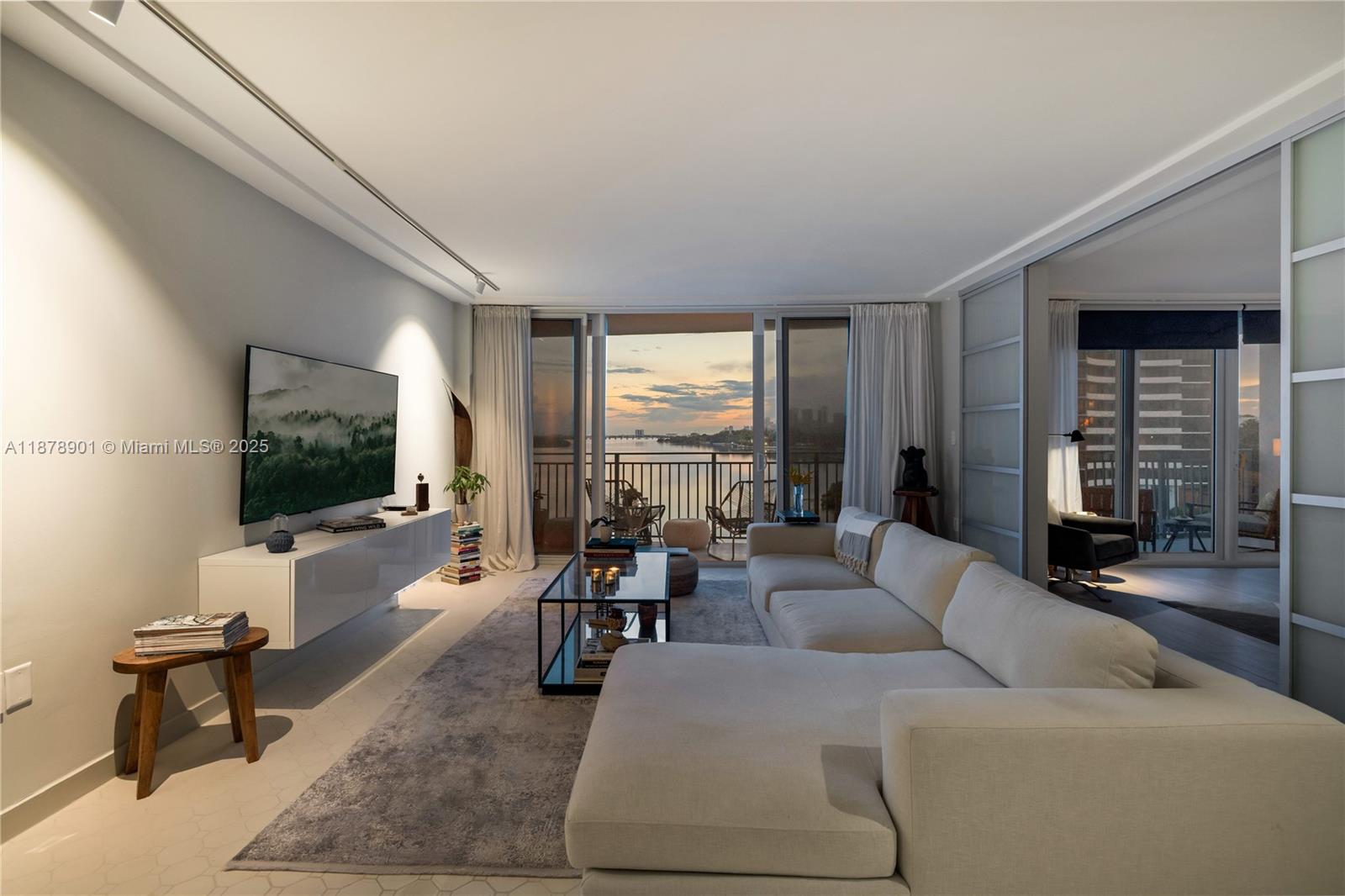 770 Northeast 69th Street, Unit 6H Miami, FL 33138 - Photo 71 of 71 a living room with furniture and a flat screen tv