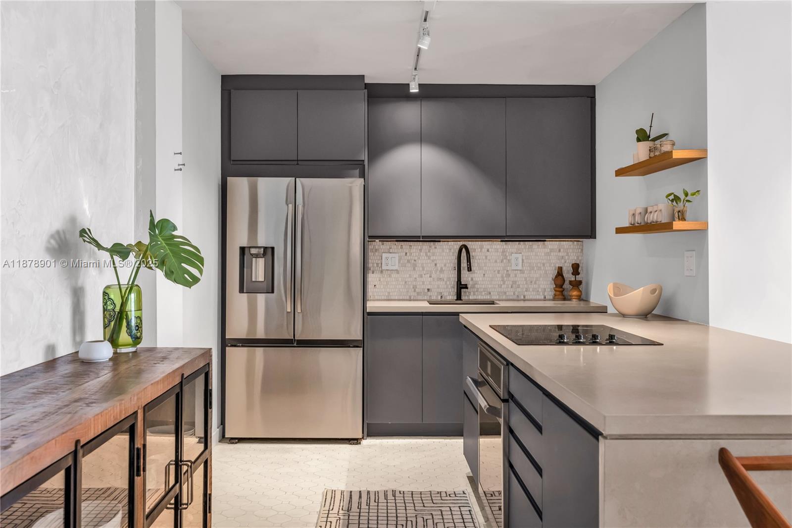 770 Northeast 69th Street, Unit 6H Miami, FL 33138 - Photo 10 of 71 a kitchen with stainless steel appliances granite countertop a sink stove and refrigerator