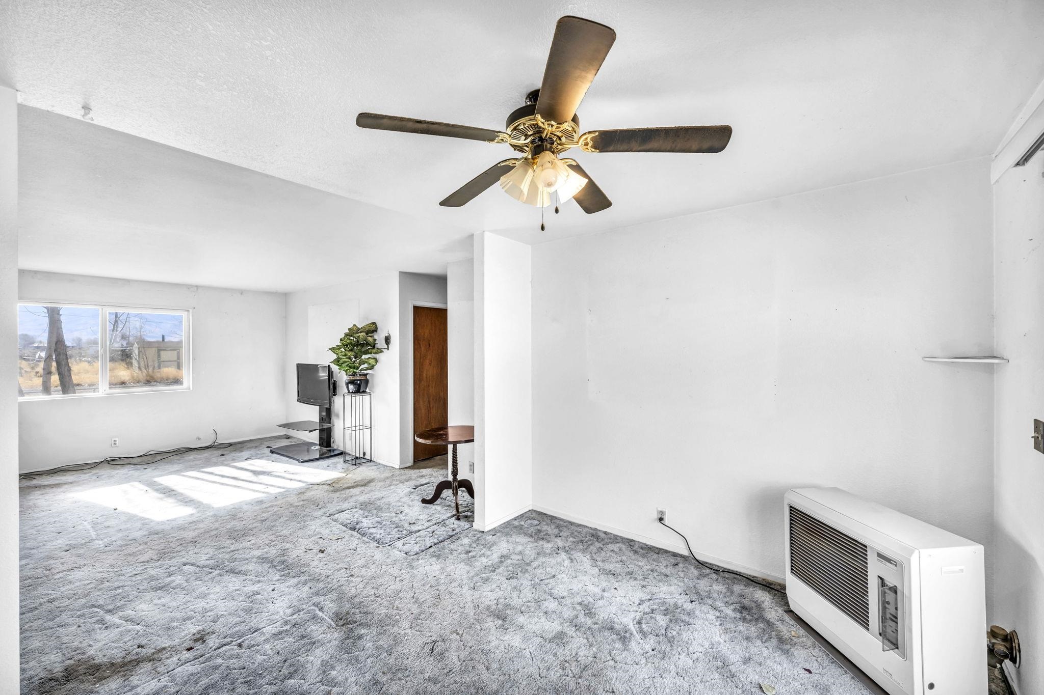 446-460 Lake View Drive Herlong, CA 96113 - Photo 5 of 13 a view of a livingroom with a stove and a ceiling fan