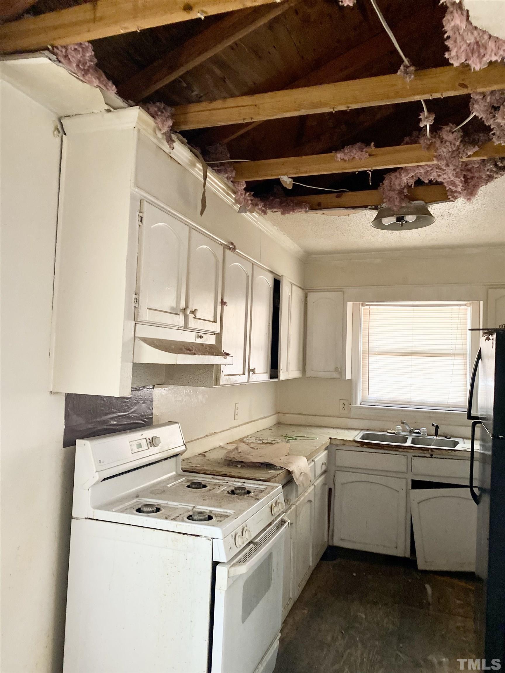 102 St Augustine Raleigh, NC 27610 - Photo 6 of 11 a kitchen with a stove and white cabinets