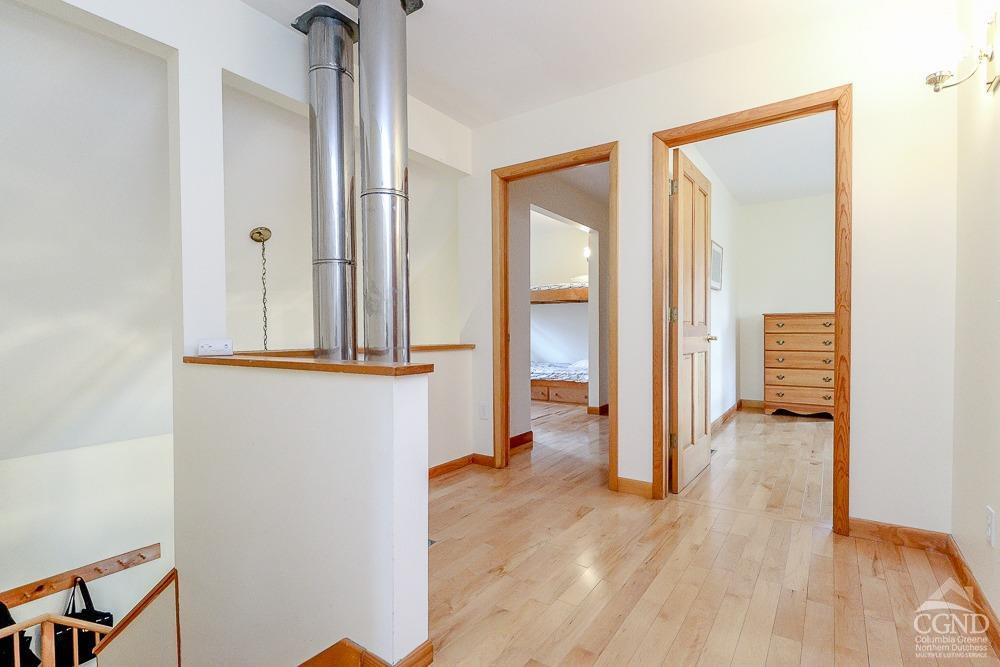 286 West Hill Road New Lebanon, NY 12125 - Photo 16 of 36 a view of a hallway with wooden floor and a bathroom