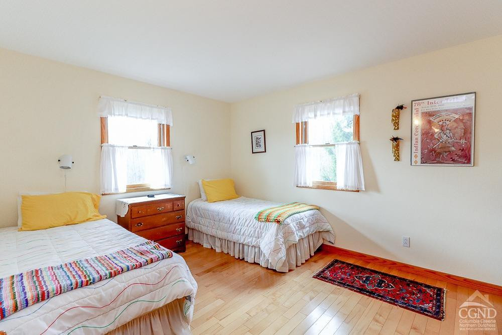 286 West Hill Road New Lebanon, NY 12125 - Photo 17 of 36 a bedroom with two beds and a window