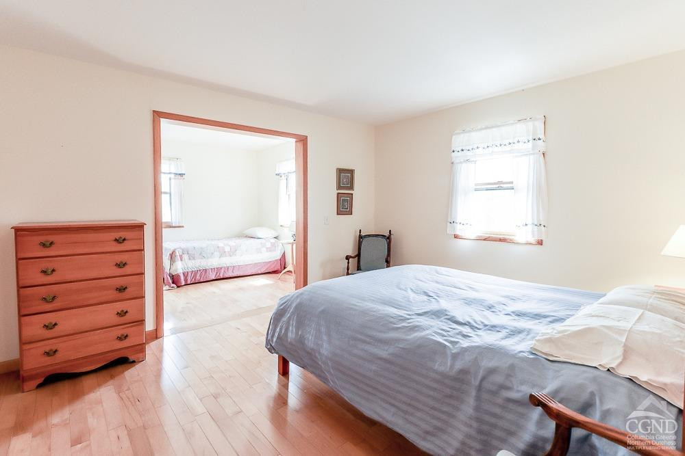 286 West Hill Road New Lebanon, NY 12125 - Photo 18 of 36 a bedroom with a bed and a dresser