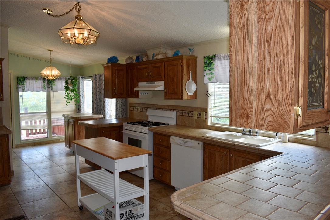 25051 Lake Shore Drive Mathis, TX 78368 - Photo 10 of 40 a kitchen with a sink cabinets and window