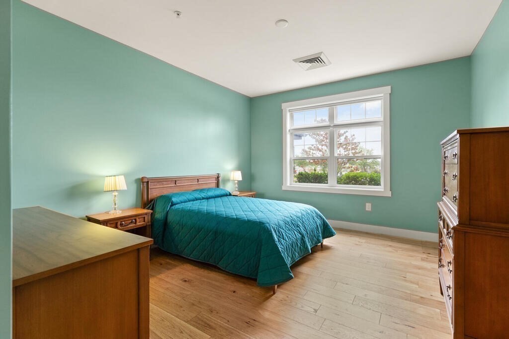 11 Executive Drive, Unit 118 Stoneham, MA 02180 - Photo 14 of 36 a bedroom with a bed and a window