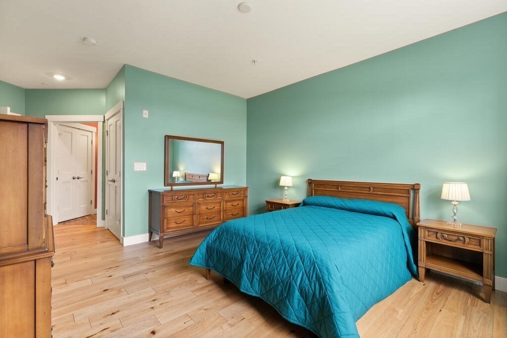 11 Executive Drive, Unit 118 Stoneham, MA 02180 - Photo 15 of 36 a bedroom with a bed and a view of bathroom