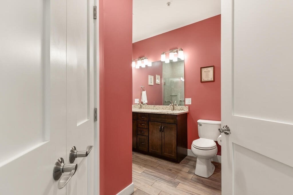 11 Executive Drive, Unit 118 Stoneham, MA 02180 - Photo 18 of 36 a bathroom with a toilet sink and mirror