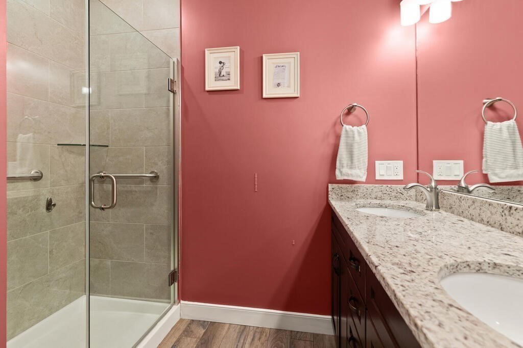 11 Executive Drive, Unit 118 Stoneham, MA 02180 - Photo 19 of 36 a bathroom with a granite countertop sink and a mirror